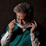 Man putting a surgical face mask